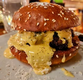 Goodkind burger with black truffle and artichoke tapenade and foie-llandaise